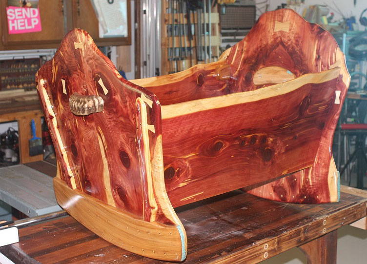 Here's the finished project -- a one-of-a-kind cedar baby cradle that'll surely become a family heirloom. The note on Jerry's wall says, "Send Help," but we think he's got his woodworking very much under control! Jerry Heater IMG_4582 _sml