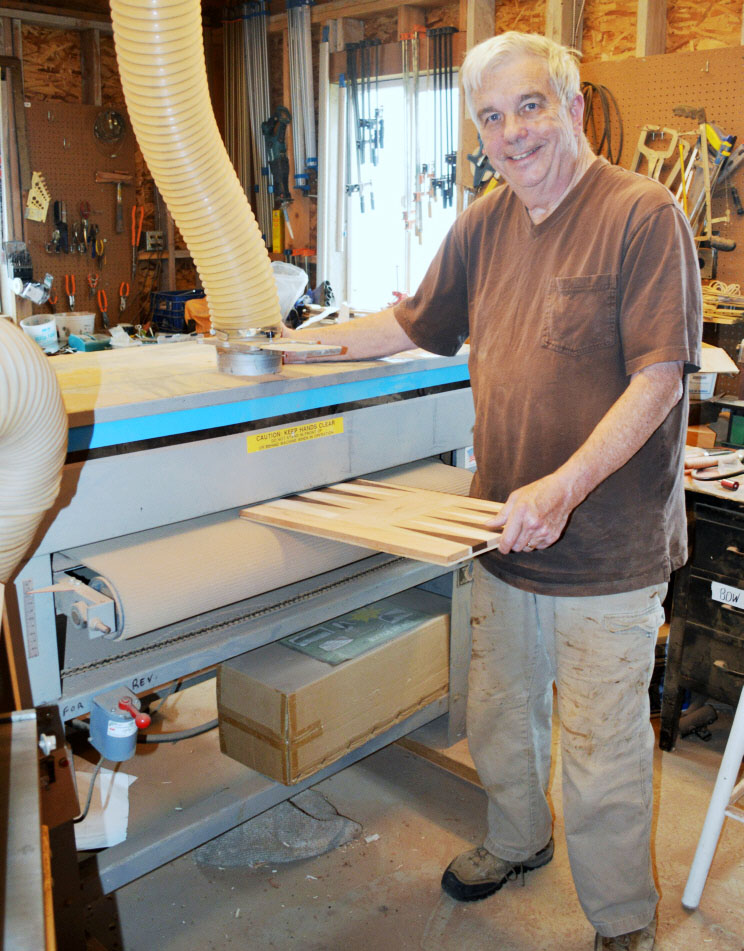Chuck runs one of his solid wood backgammon boards through his 38% Woodmaster Drum Sander to get a perfectly smooth, even, perfect surface.